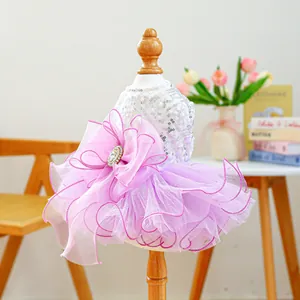 Close-up of lavender pet wedding dress with rhinestone bow and layered tulle skirt