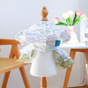Floral pet dress detail featuring vintage puff sleeves and delicate lace hemline