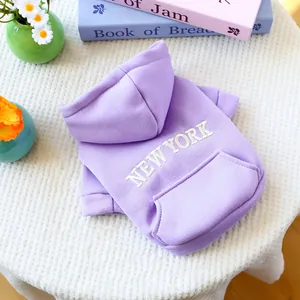 Close-up of purple pet hoodie featuring white New York embroidery and soft fleece texture