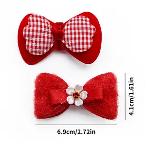 Detailed size view of red bow pet hair clips with 6.9cm width and plush fabric texture