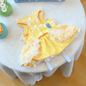 Detailed view of yellow daisy dog dress with lace trim and cute cartoon embroidery