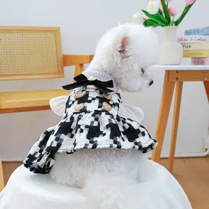 Detail of pet dress with houndstooth pattern, velvet bow, and pearl decoration