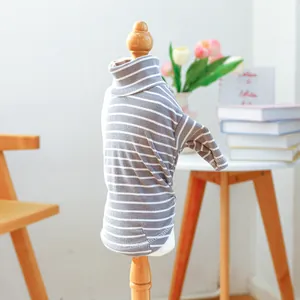 Detail of grey striped turtleneck dog sweater showing fine knit texture on a wooden model