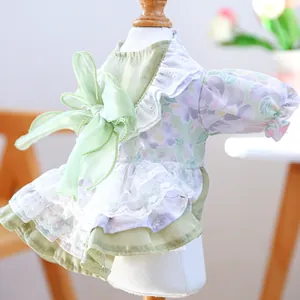 Detailed view of floral pet dress with large silk bow and white lace trim
