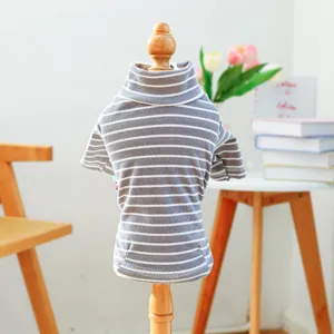 Close-up of striped turtle neck pet shirt on a wooden model in a cozy home setting