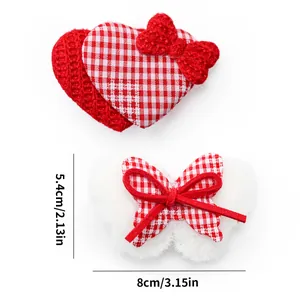 Detail showing red heart and white bow pet hair clips with 8cm measurement scale