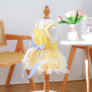 Detailed close-up of yellow pet daisy dress with embroidery and mesh layers