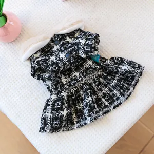 Detail of tweed pet dress showing black and white check pattern with faux fur collar