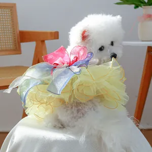 Dog princess tutu dress featuring yellow mesh layers and a colorful gradient bow accessory
