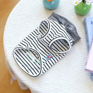 Flat lay of striped and grey waffle texture pet vests on a minimalist textured surface