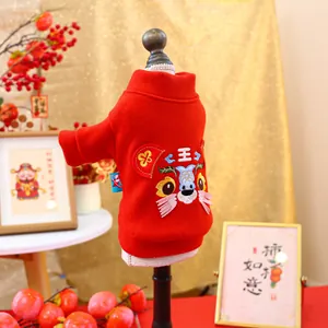 Detail of red pet sweater with tiger embroidery and traditional festive decorations