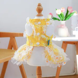 Close-up of a yellow dog summer dress with white daisy prints and mesh lace edges