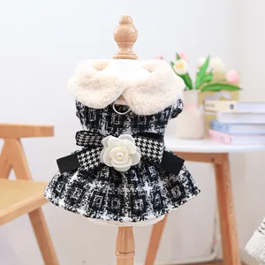 Close-up of houndstooth pet dress with faux fur collar and 3D flower bow detail