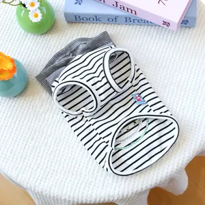 Close-up of black and white striped pet vest with blue cartoon patch on waffle fabric