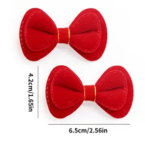 Detailed size view of red velvet bow clips for dogs showing 6.5cm width dimensions