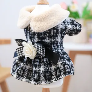 Detail of pet dress featuring a pearl-centered flower on a black ribbon and faux fur collar