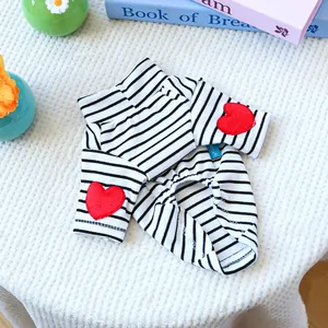 Detail of black and white striped pet shirt with red heart embroidery on the sleeves