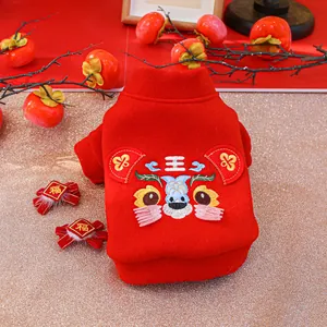 Close-up of a red pet New Year hoodie with traditional tiger embroidery and matching clips