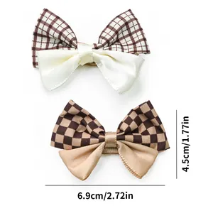 Detailed view of plaid and satin bow pet hair clips with 6.9cm x 4.5cm dimensions