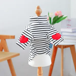 Detail of black and white striped pet shirt with red heart patches on sleeves