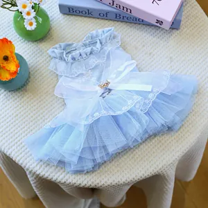 Detail of light blue pet dress featuring lace, tulle layers and a large silk bow with pearls