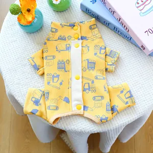 Detail of yellow pet dog pajamas with car patterns and functional snap buttons