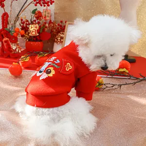 Detail of red pet sweater with dragon embroidery and thick festive fabric on a dog