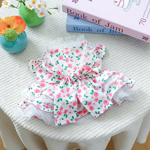 Detail of floral dog dress with large bow, lace trim and tiered skirt design