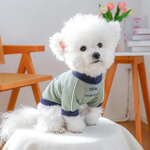 Detail of waffle knit fabric on green pet vest with Goal Hunter print on dog clothing