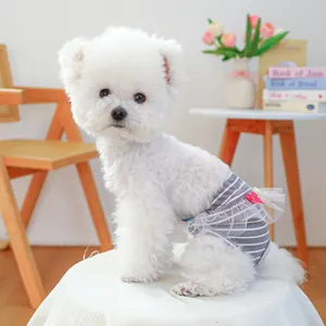 Dettaglio dei pantaloni fisiologici a righe per cani con pizzo e fiocchi rosa