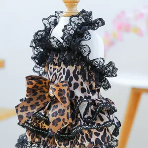 Detail of leopard print pet dress with black lace ruffles and rhinestone bow decor