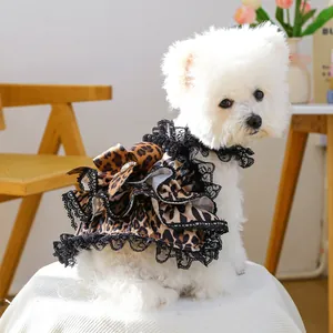 Detail of leopard print pet dress with black lace trim and large bow for small dogs