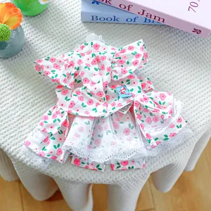 Detailed macro view of small dog floral summer dress with lace hem and decorative buttons