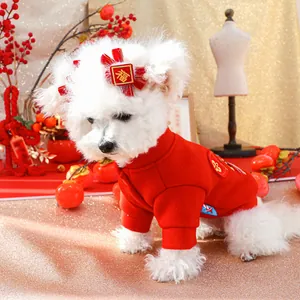 Detail of red pet New Year outfit with golden Fu character and matching bow hair clip