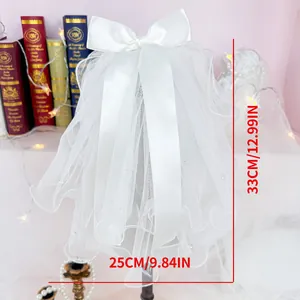 Detail of white bridal dog veil with pearls and satin bow for small pet wedding outfit