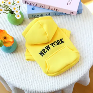 Yellow dog hoodie with New York print and kangaroo pocket on waffle background