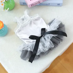 Detail of pet princess dress with a satin bodice, lace trim, and a large black bow ornament