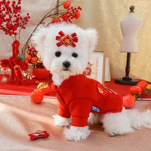 Detail of red festive dog hoodie with gold Fu character embroidery and matching bow