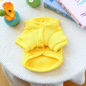 Macro detail of a bright yellow fleece dog hoodie with snap buttons and soft lining