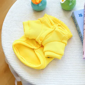 Close-up of a bright yellow pet fleece sweatshirt with three buttons and soft texture