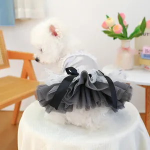 Detail of grey satin pet dress with white tulle tutu and large black bow on a dog