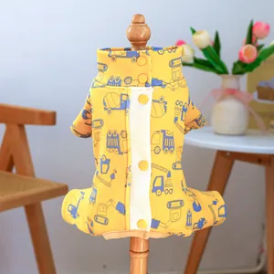 Yellow pet jumpsuit with blue construction vehicle patterns on a wooden model stand