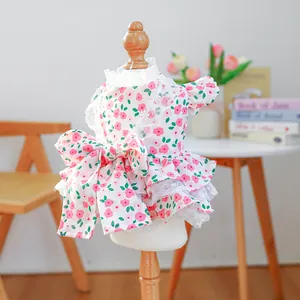 Detailed close-up of pet floral dress with a large bow and elegant lace trim details