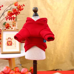 Detail of red pet hoodie on mannequin with festive New Year decorations