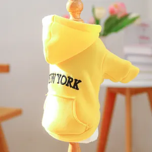 Detail of yellow pet hoodie with black New York embroidery and decorative pocket