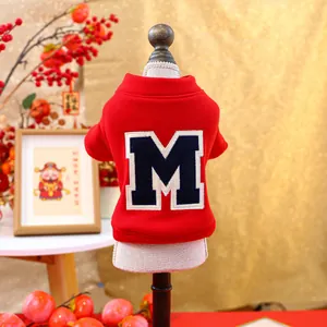 Detail of red festive pet sweatshirt featuring white lace collar and navy M patch