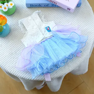 Detailed view of dog dress featuring white lace top, purple mesh skirt and back buttons