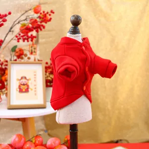 Detail of red festive pet sweatshirt with buttons and ribbed cuffs on a miniature mannequin