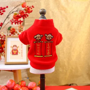 Close-up of festive red pet hoodie with cartoon embroidery and Chinese New Year motifs
