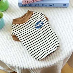 Flat lay of vintage striped pet vest with brown ribbed edges and retro chest patch
